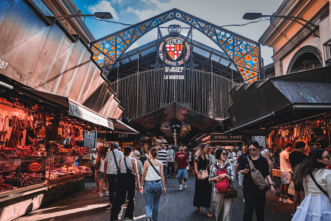 Colorful fruit and jamon stalls inside La Boqueria market in Barcelona