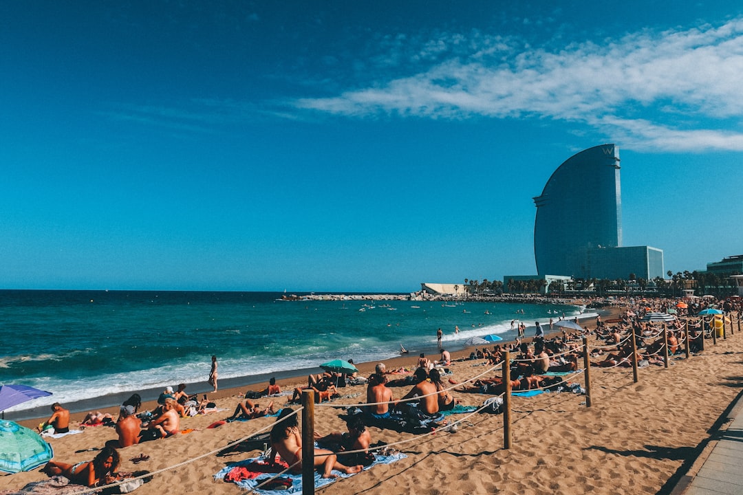 Barceloneta beach with palm trees and the W Hotel in the background