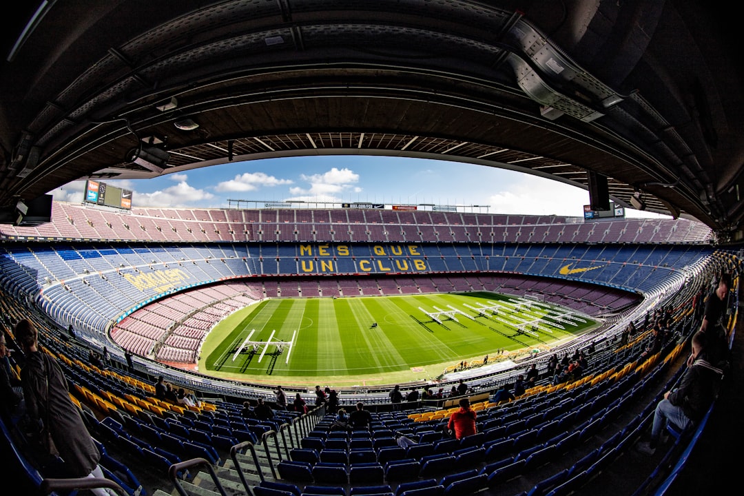 Camp Nou stadium interior with green pitch and empty stands