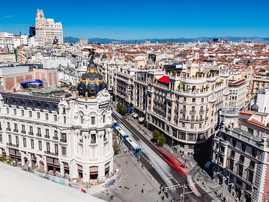 Gran Via Madrid lit up at night with traffic and historic buildings