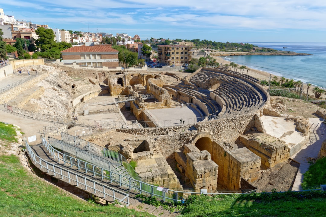 Ancient Roman amphitheater with stone seating tiers at Italica